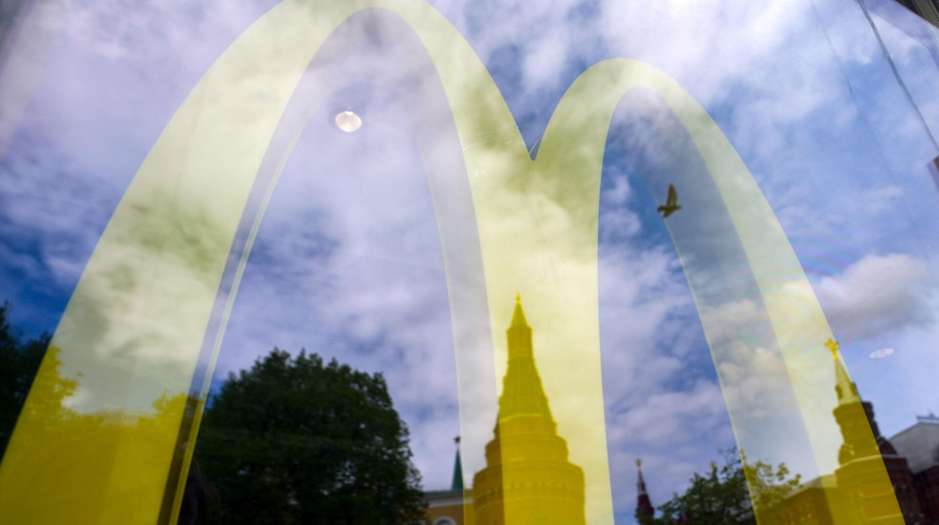 The Kremlin’s towers are seen reflected in the window of a closed McDonald’s restaurant in Moscow on May 16, 2022.