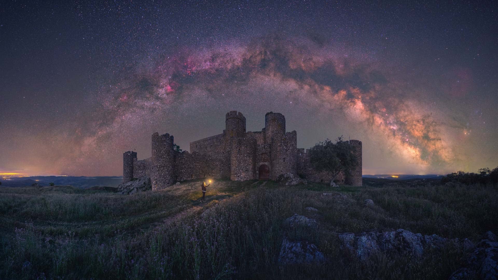 A castle under the arch of the Milky Way.