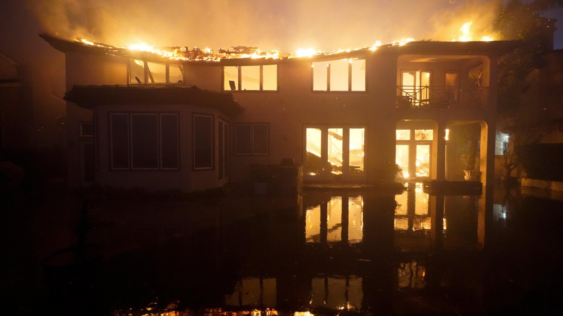 A structure burns during a wildfire Wednesday, May 11, 2022, in Laguna Niguel, Calif. 