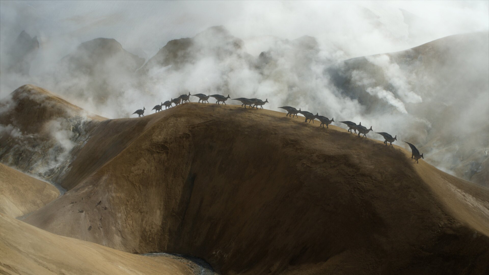 A herd of Olorotitans scaling a large dune.