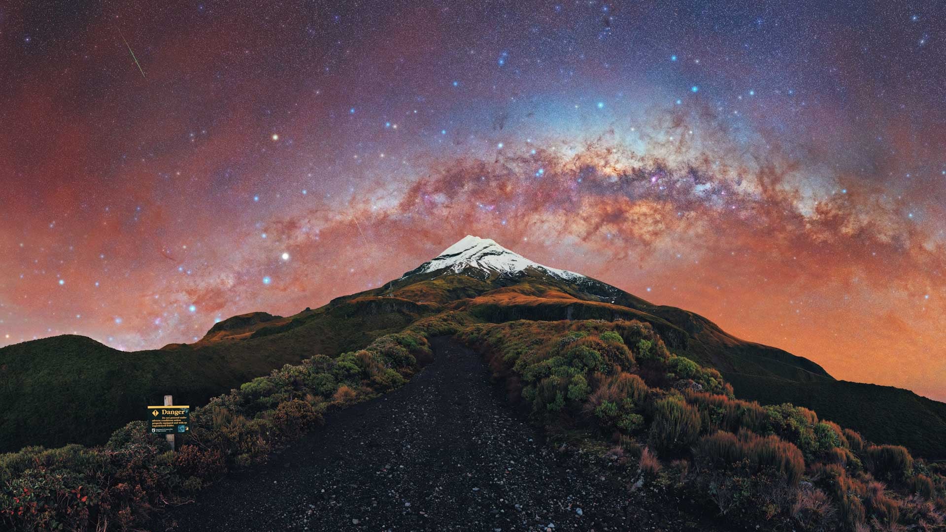 A starburst of color from the Milky Way behind New Zealand’s Mount Taranaki.