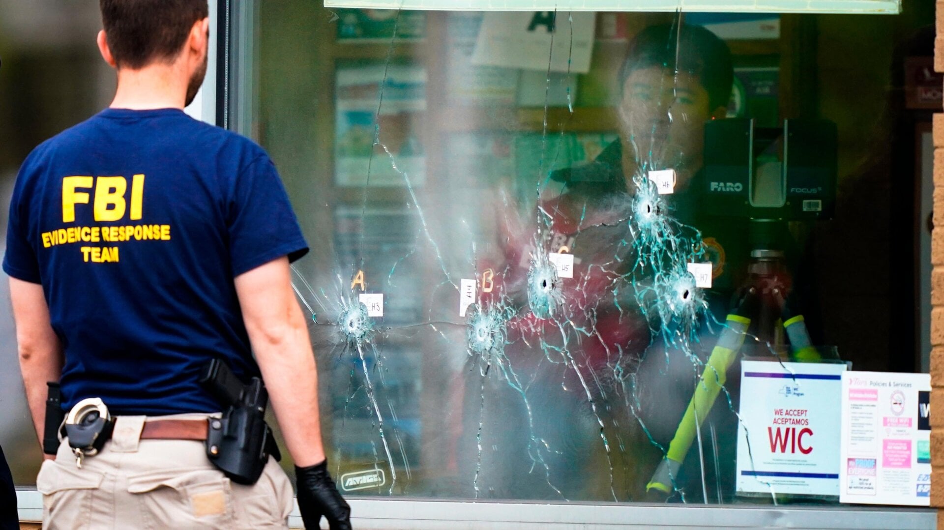 Investigators work at the scene of a terrorist shooting at a supermarket in Buffalo, New York on May 16, 2022.