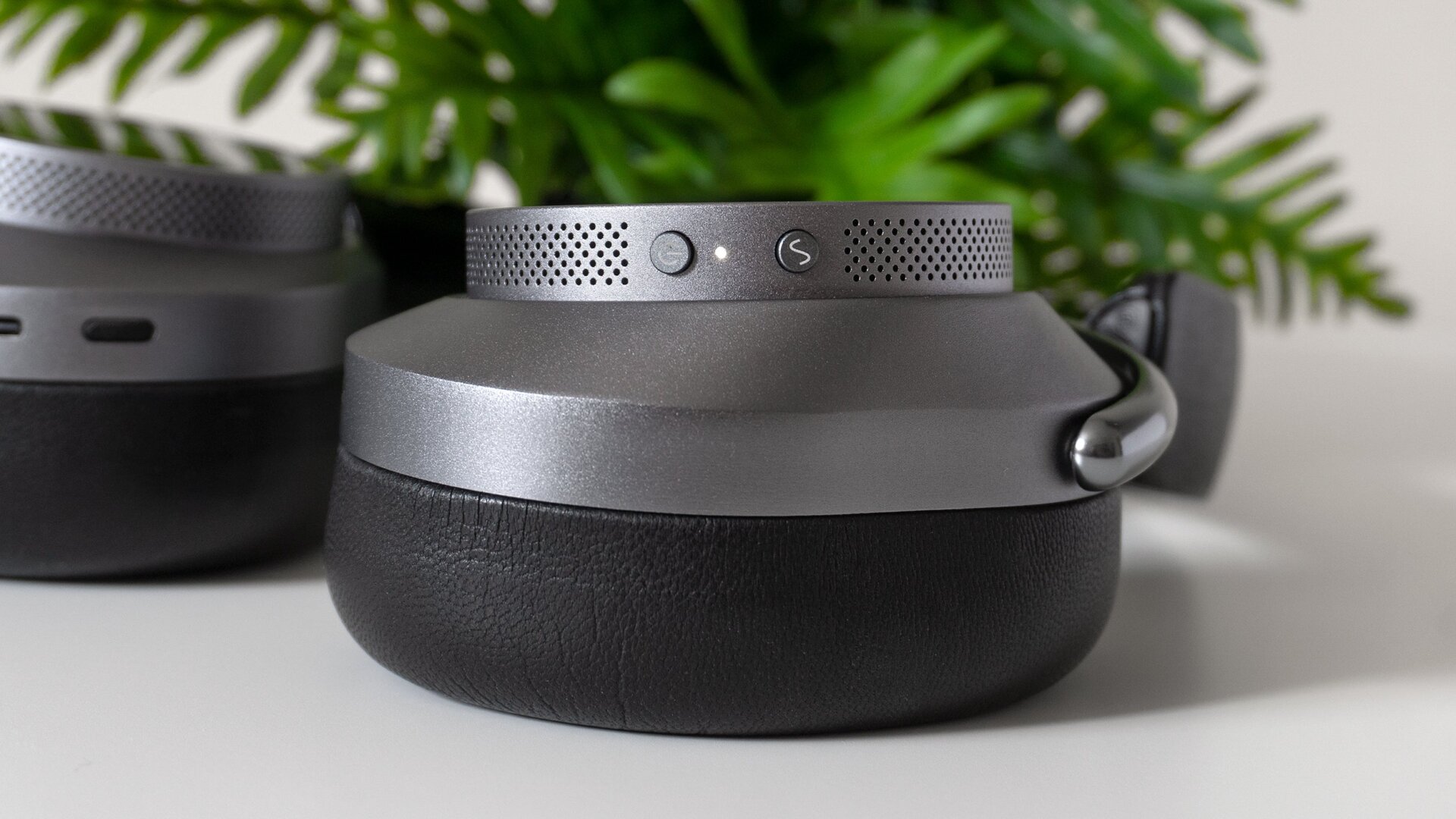 The Master & Dynamic MW75's left ear cup features a power button and a button for switching between ANC modes.