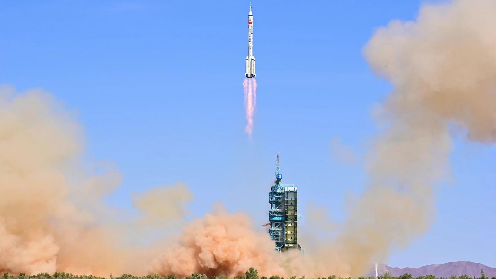 The three-person crew launched from the Jiuquan Satellite Launch Center in the Gobi Desert.