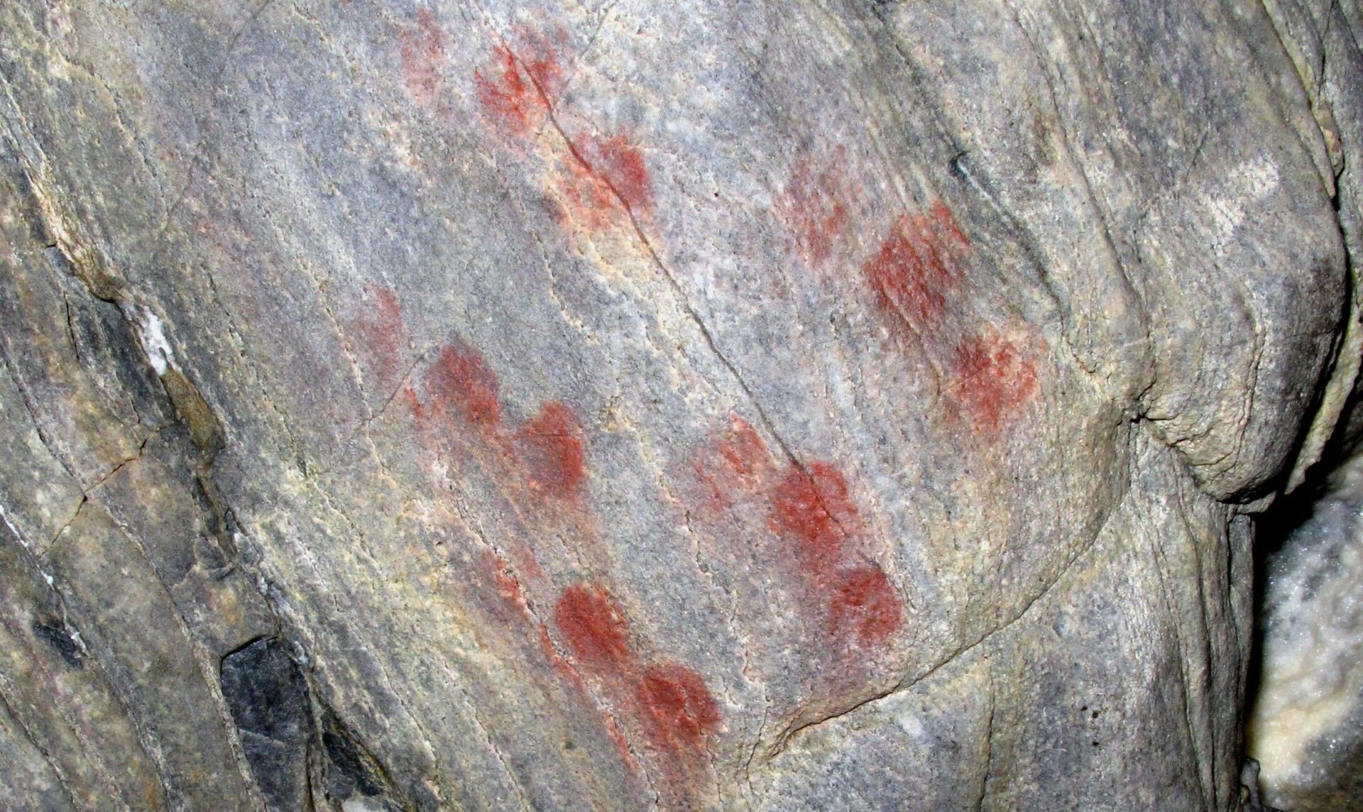 Abstract red dots on the cave wall.
