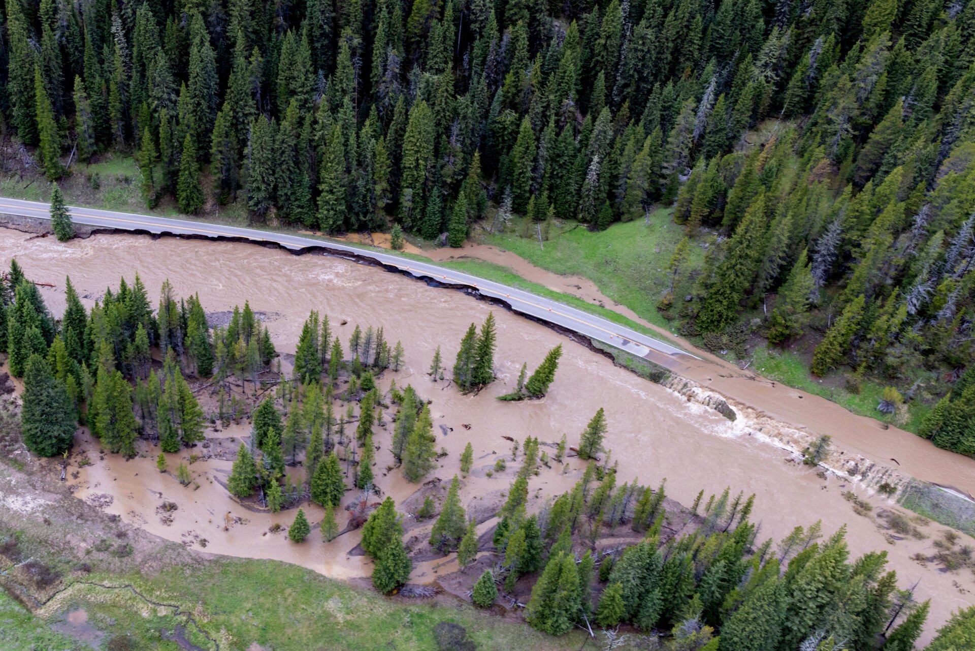 This aerial photo provided by the National Park Service shows a flooded  out North Entrance Road, of Yellowstone National Park in Gardiner,  Mont., on June 13, 2022.