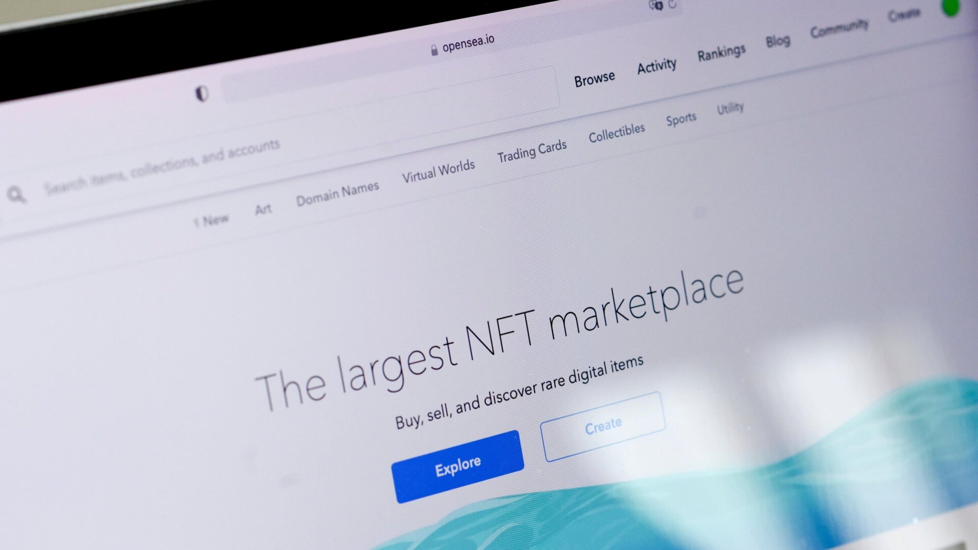 A screen shows the website Opensea