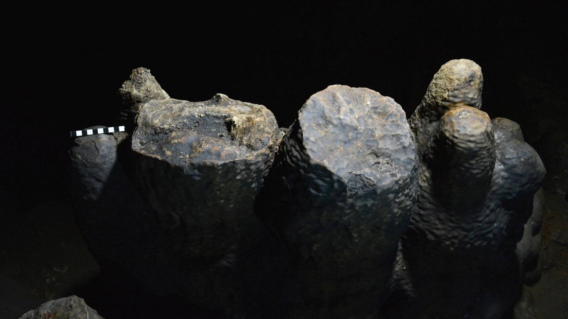 Charcoal residue in a capped stalagmite (left).