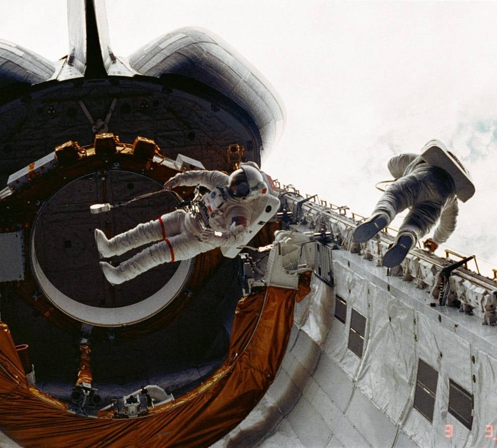 STS-6 astronauts F. Story Musgrave (left) and Donald H. Peterson during the first Shuttle EVA in 1983.