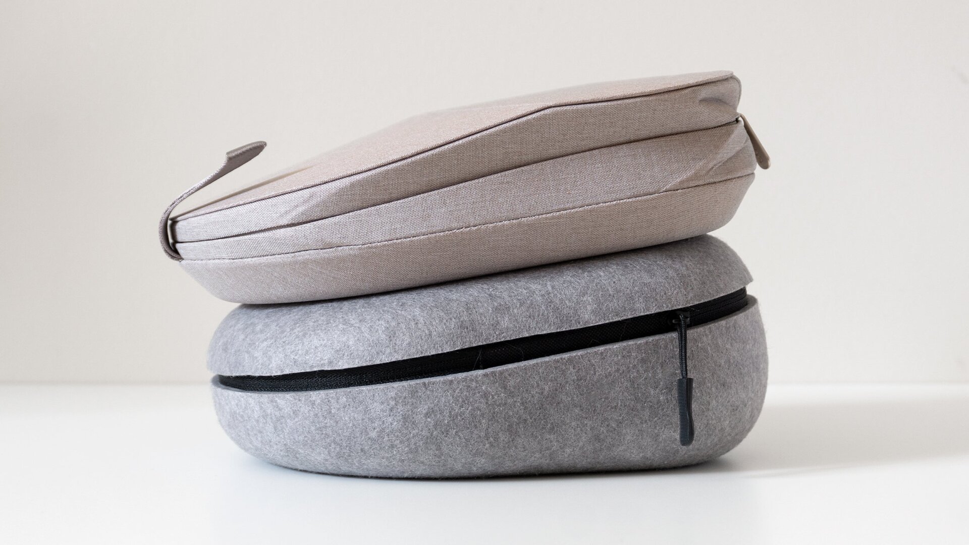 The Master & Dynamic MW75's carrying case (bottom) is much thicker than the Sony WH-1000XM5's case (top) and doesn’t collapse smaller when the MW75s are removed.