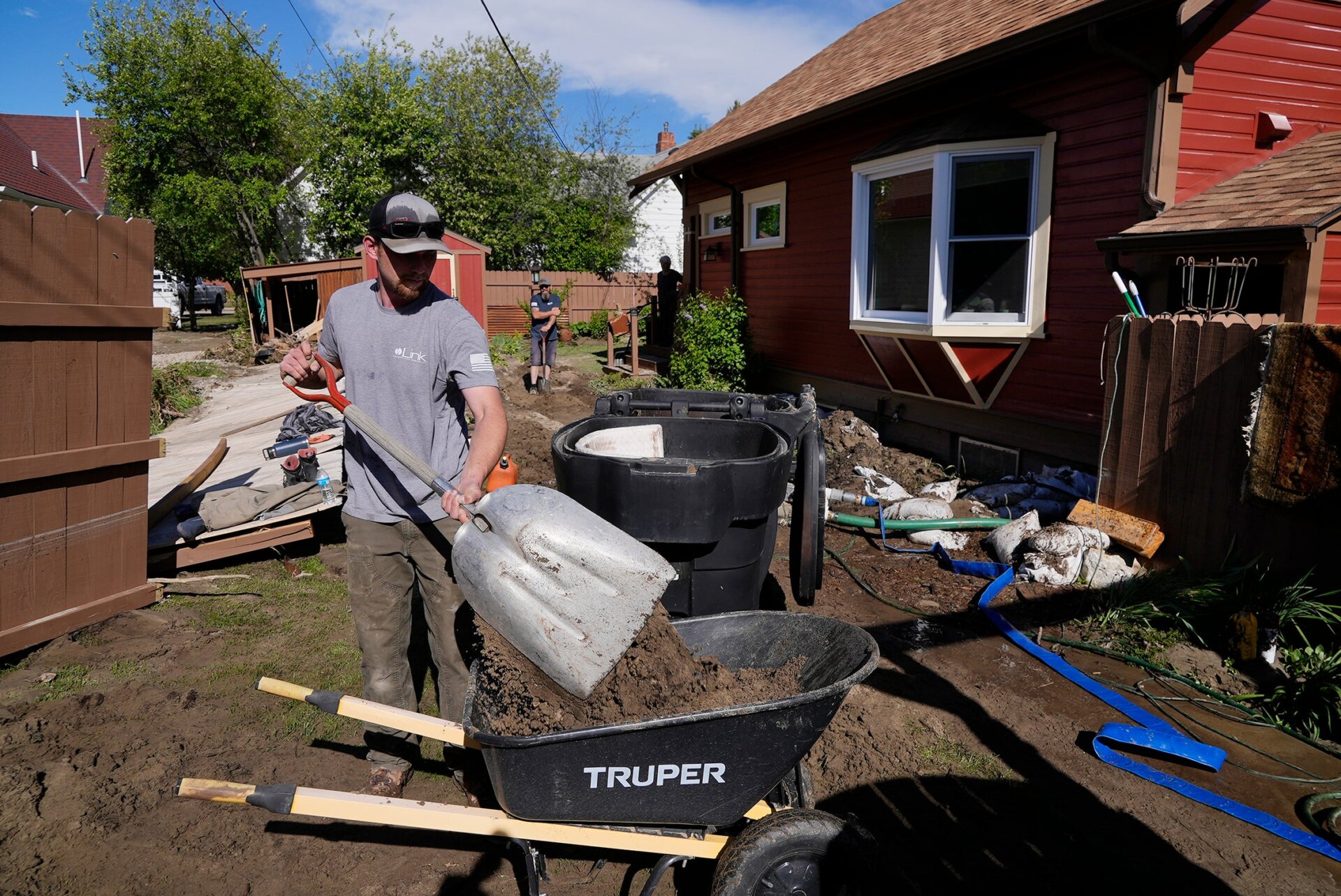 Even as flooding continues and the threat of more snowmelt and rain looms, clean-up efforts are already underway in the park and surrounding communities. Here, Tyler Bohan shovels mud left behind in the town of Red Lodge by Rock Creek.