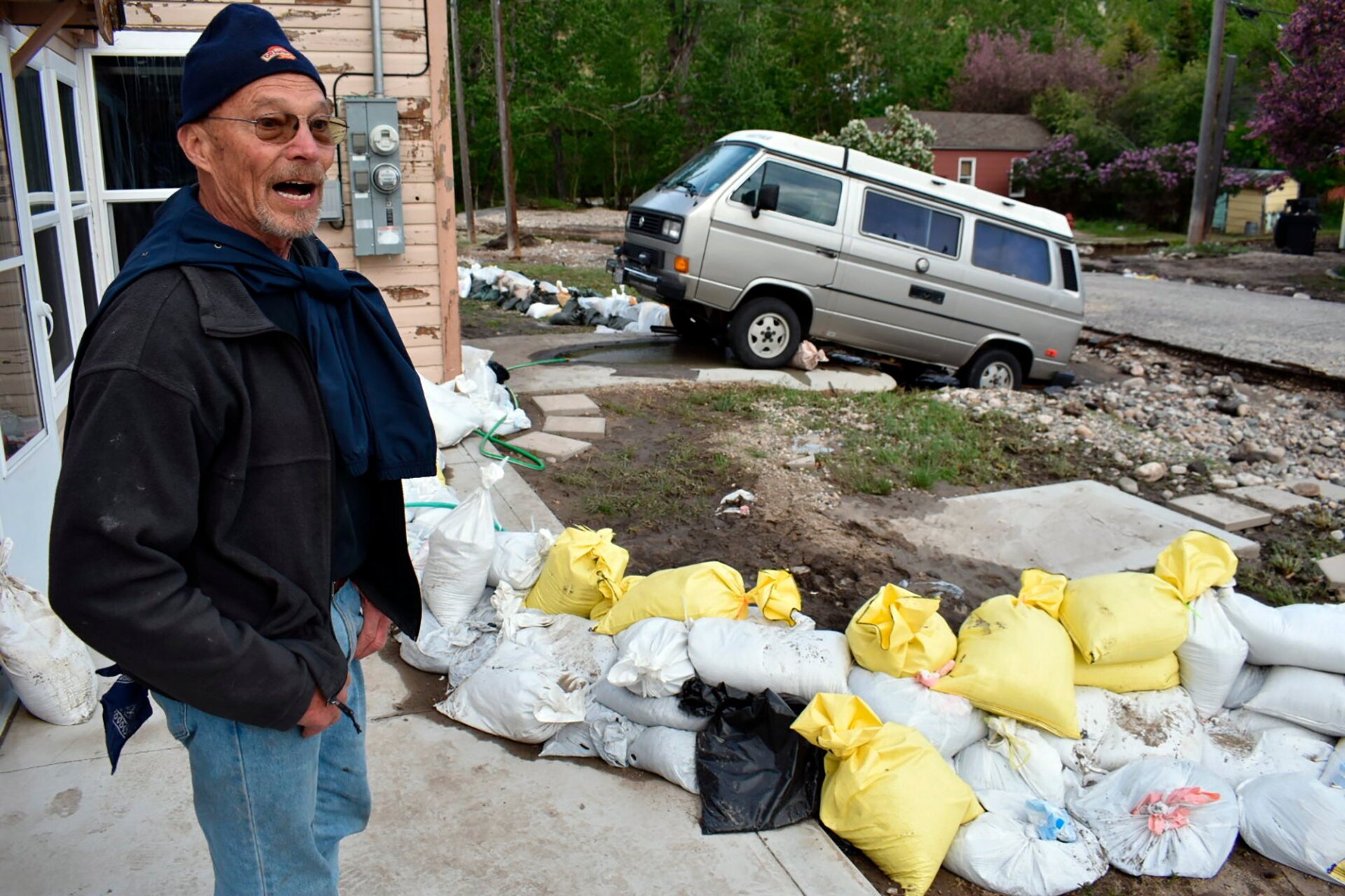Ken Ebel is seen in front of his flood-damaged house and yard, Tuesday, June 14, 2022, in Red Lodge, Mont.