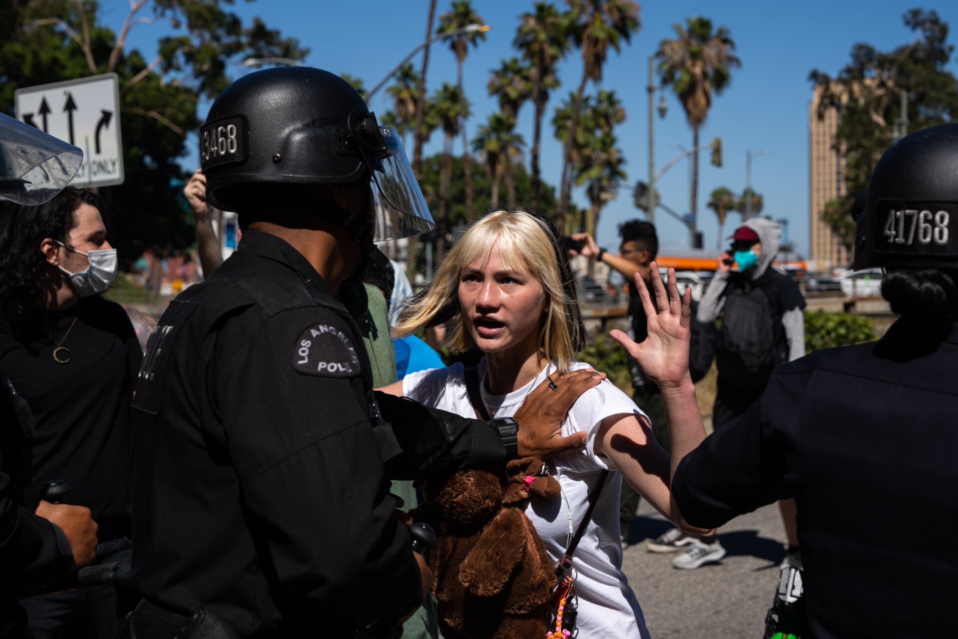 LAPD officers hold back activists as they attempted to walk onto the  110 freeway to protest the overturning of Roe v. Wade on June 25, 2022  in Los Angeles, California