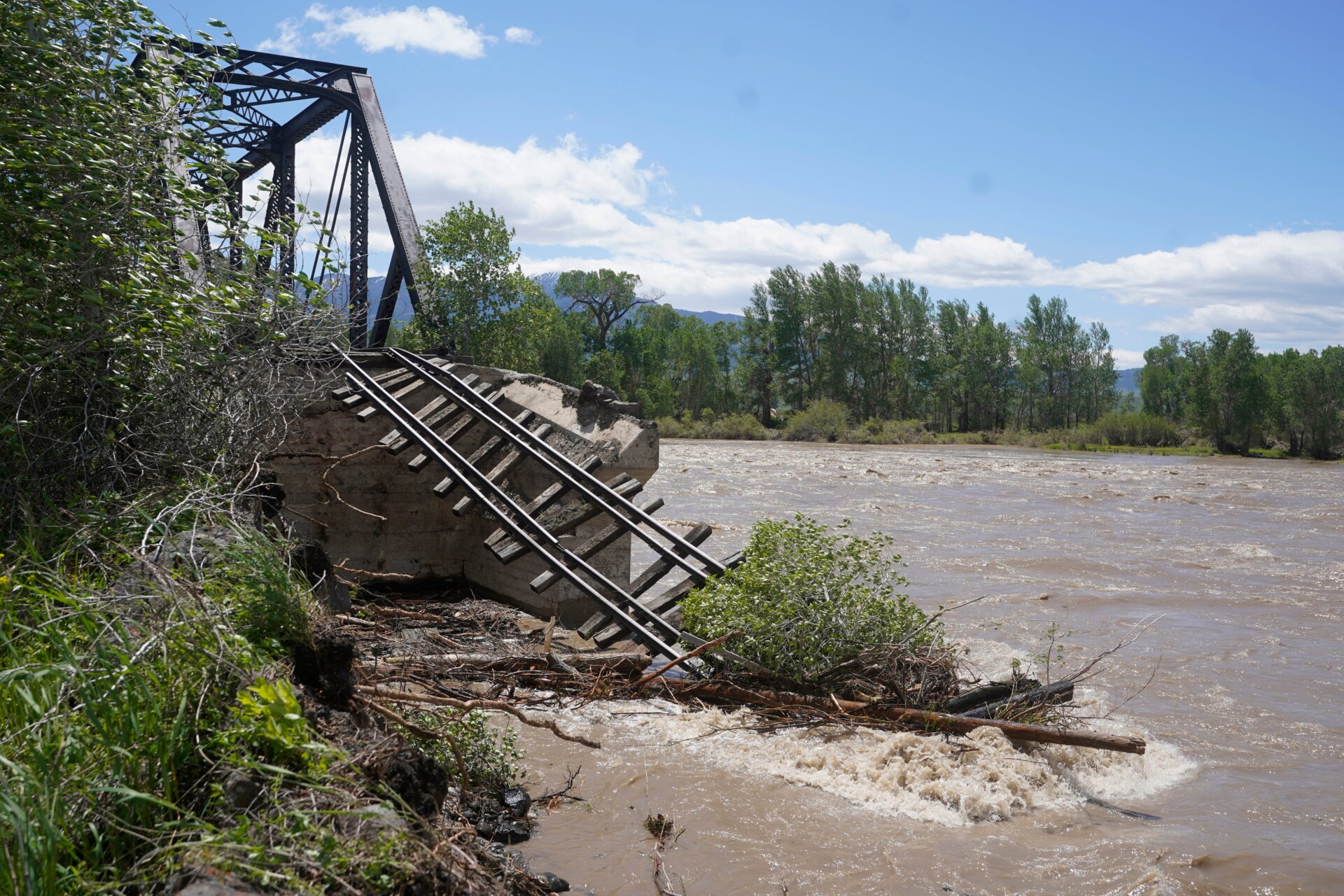 Many of the repairs will take a long time to complete. Infrastructure, like this train bridge near Livingston, Montana, has been heavily damaged.