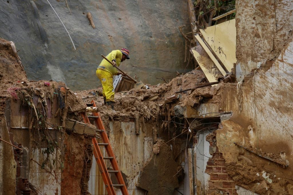 A man removes debris on a landslide area at the community Jardim Monte Verde in Recife, Brazil. 