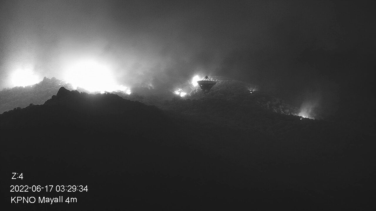 Part of the Contreras Fire burning on the slopes of the Kitt Peak mountain on early morning June 17. In the foreground NRAO’s Very Long Baseline Array Dish is seen.