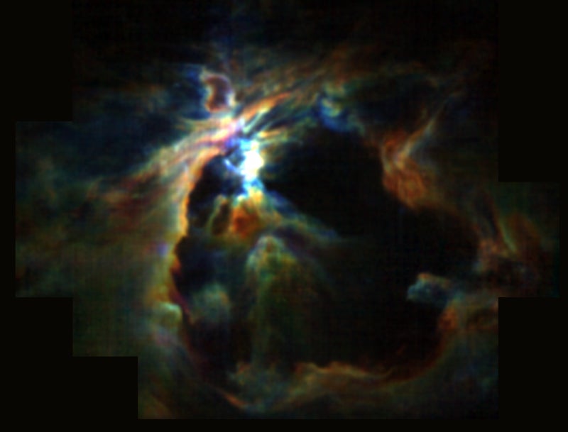 The core of the Orion Nebula. The dark area is the result of powerful winds from a newly formed star, which is preventing new stars from forming.