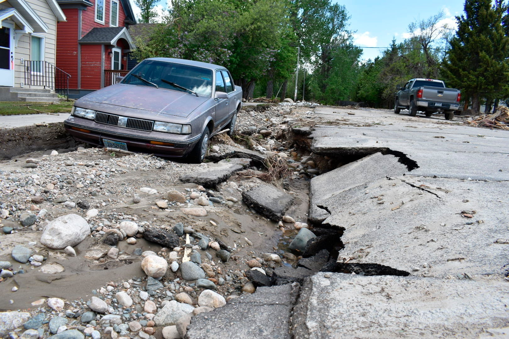 Flood damage is seen along a street Tuesday, June 14, 2022, in Red Lodge, Mont.