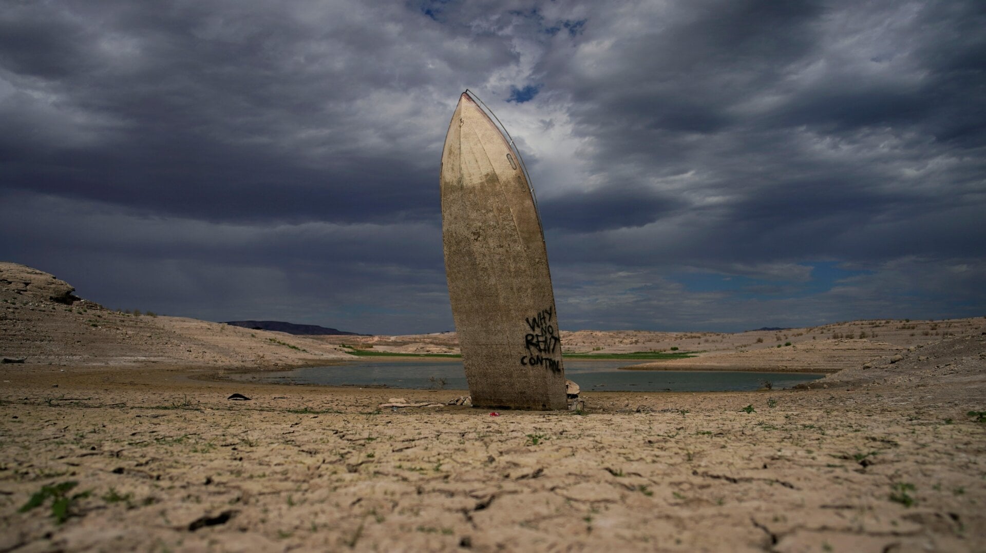A formerly submerged boat sticks straight out of newly exposed ground at Lake Mead.