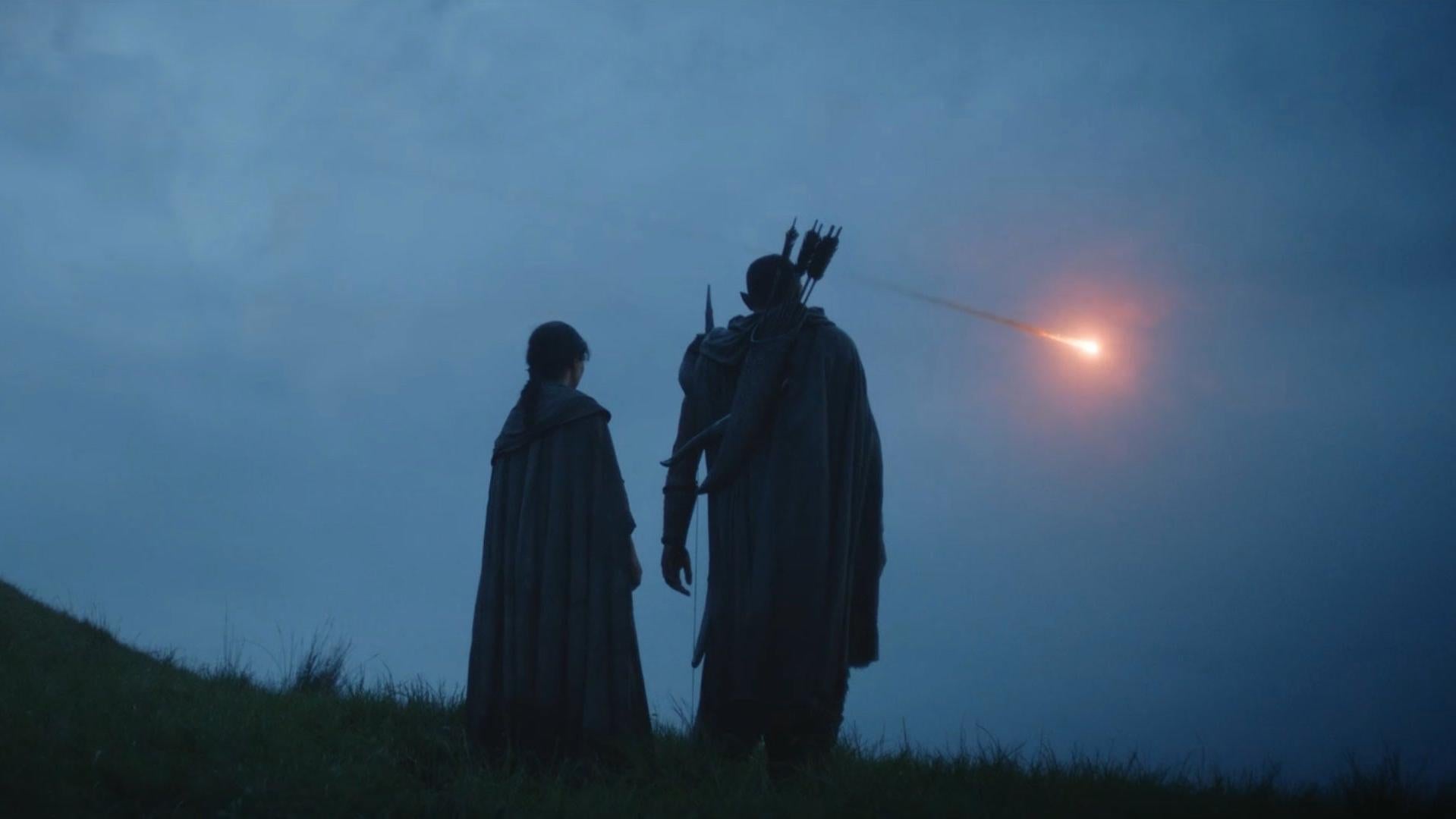 Arondir (Ismael Cruz Cordova) and Bronwyn (Nazanin Bonidai) watch something in the sky in a new trailer for The Lord of the Rings: The Rings of Power.
