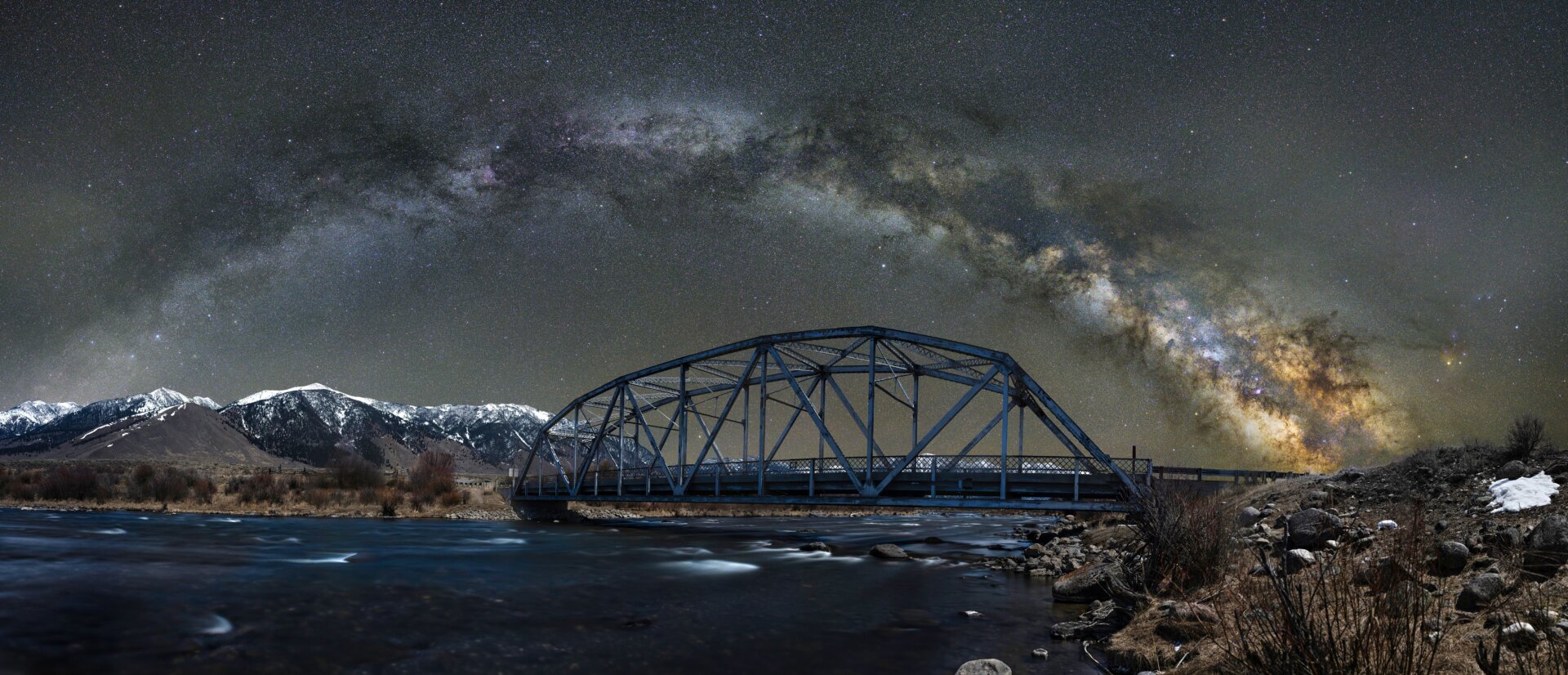 A bridge in Montana, the Milky Way behind it.