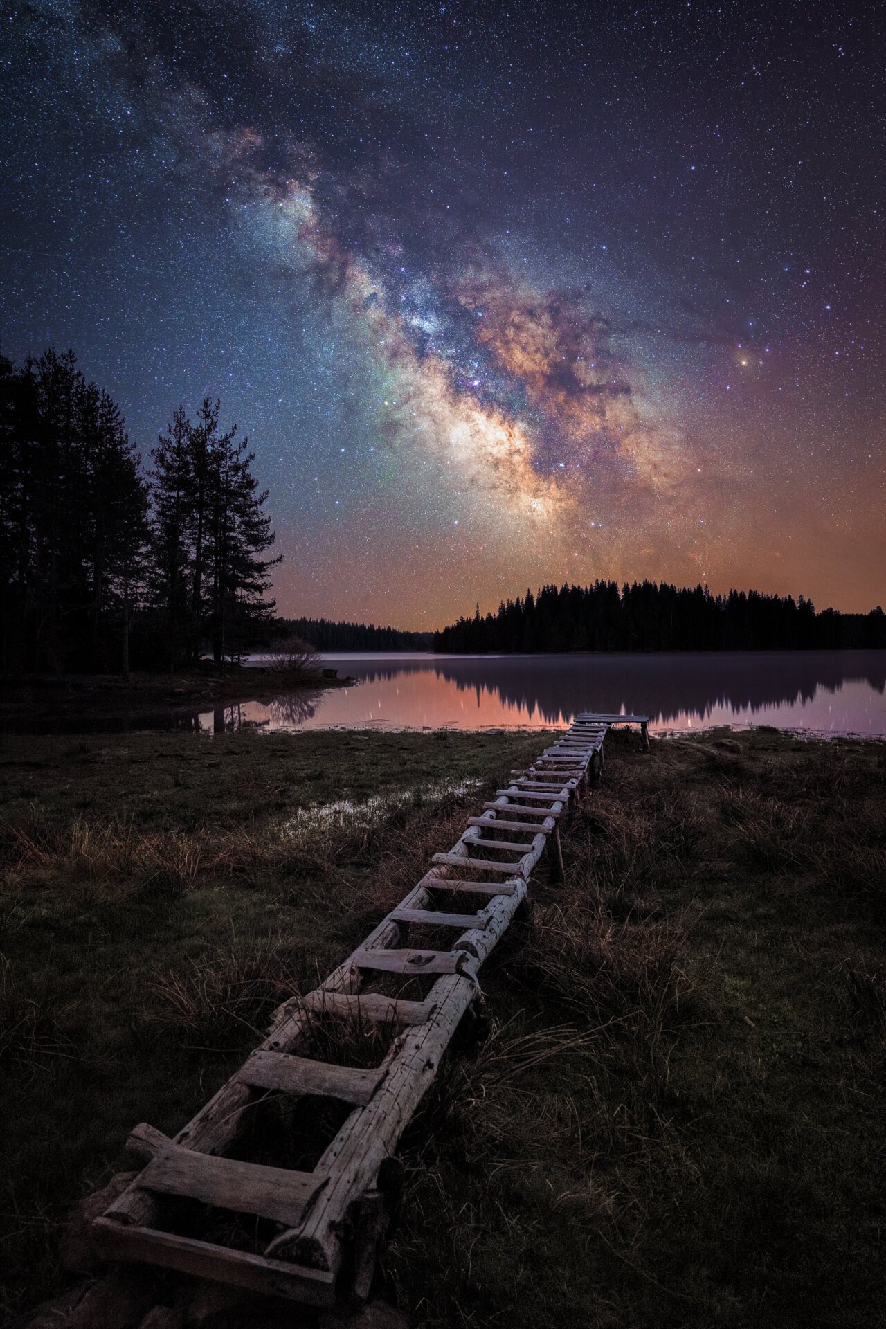 A wooden step structure in Bulgaria, the Milky Way looming above.