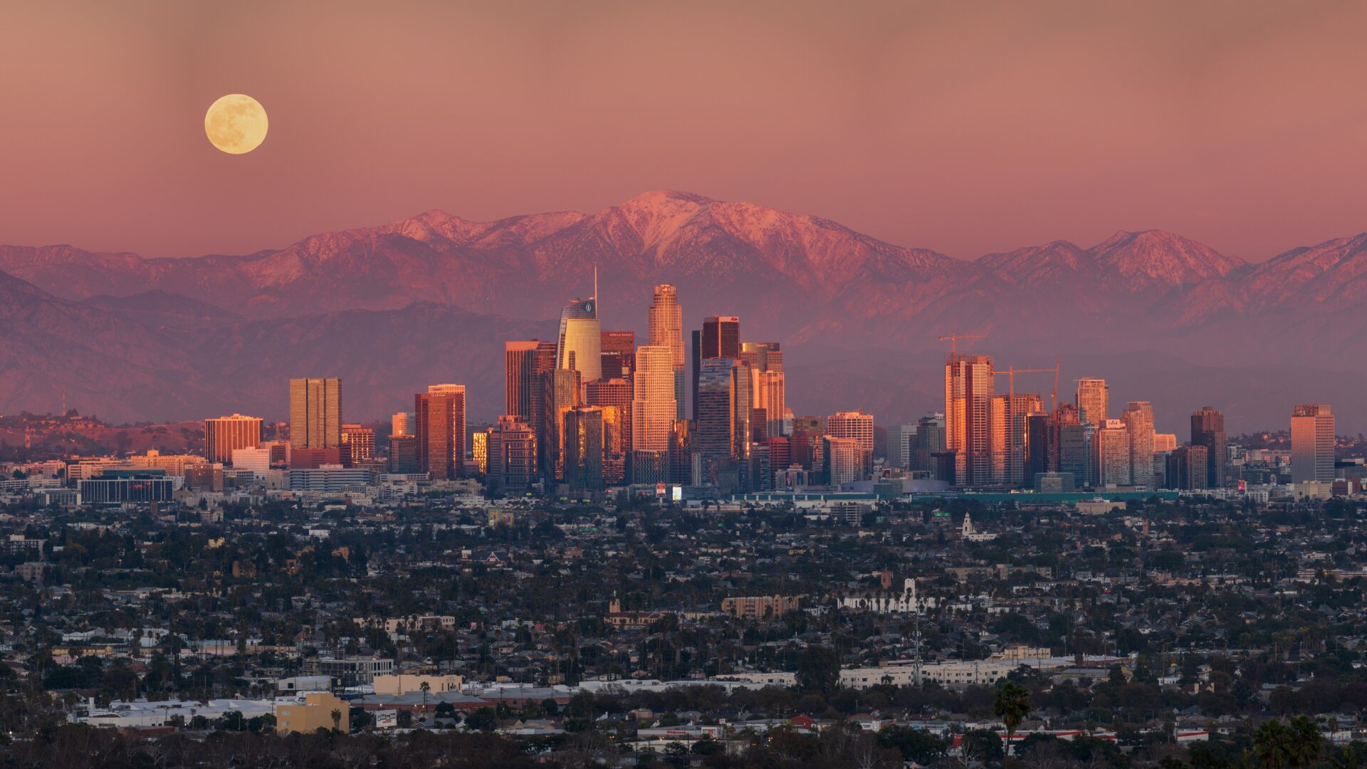 Los Angeles, with the mountains and Moon behind it. 
