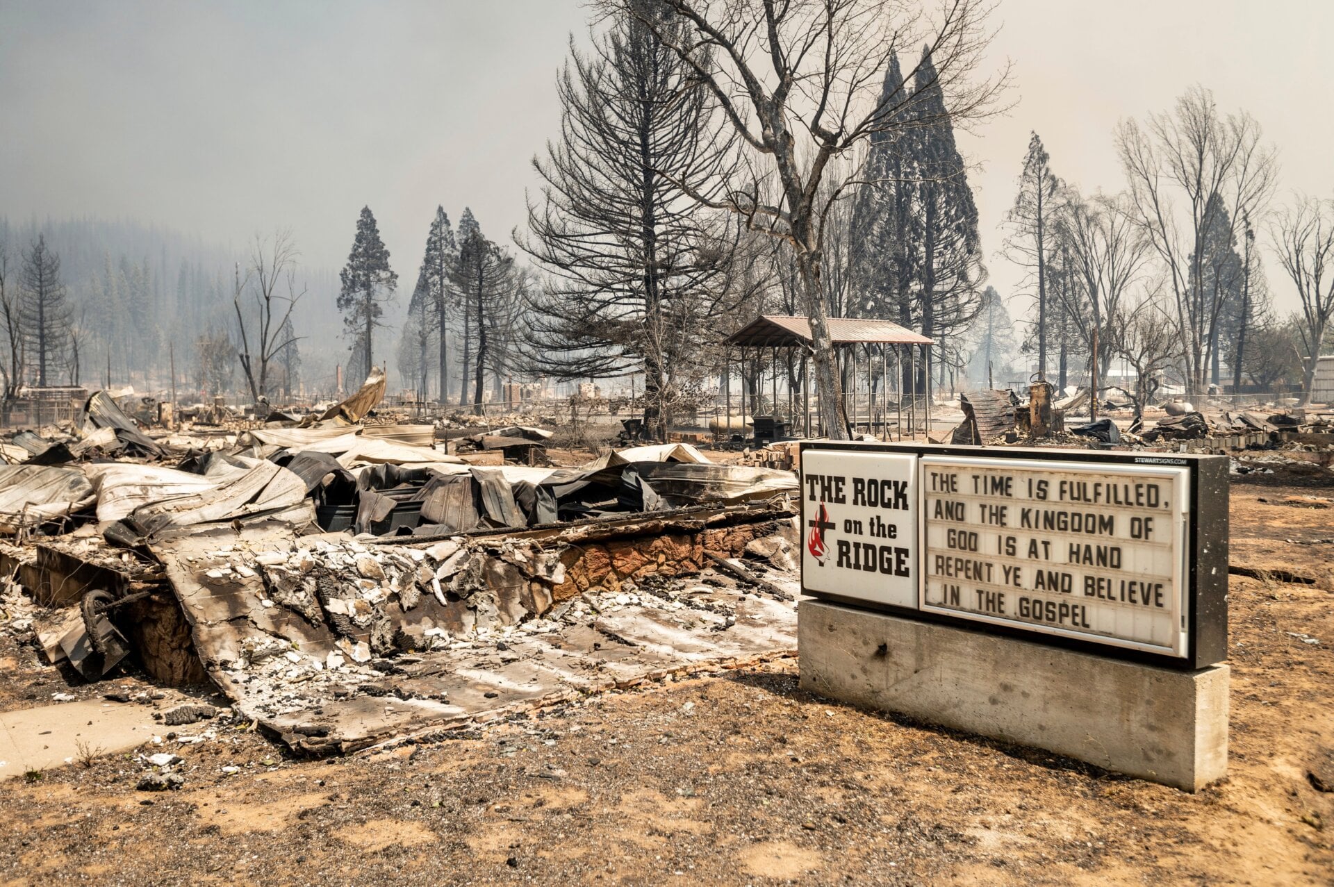 After the 2021 Dixie Fire swept through, the only thing left of this block of burned buildings in Greenville, California was the church sign. 