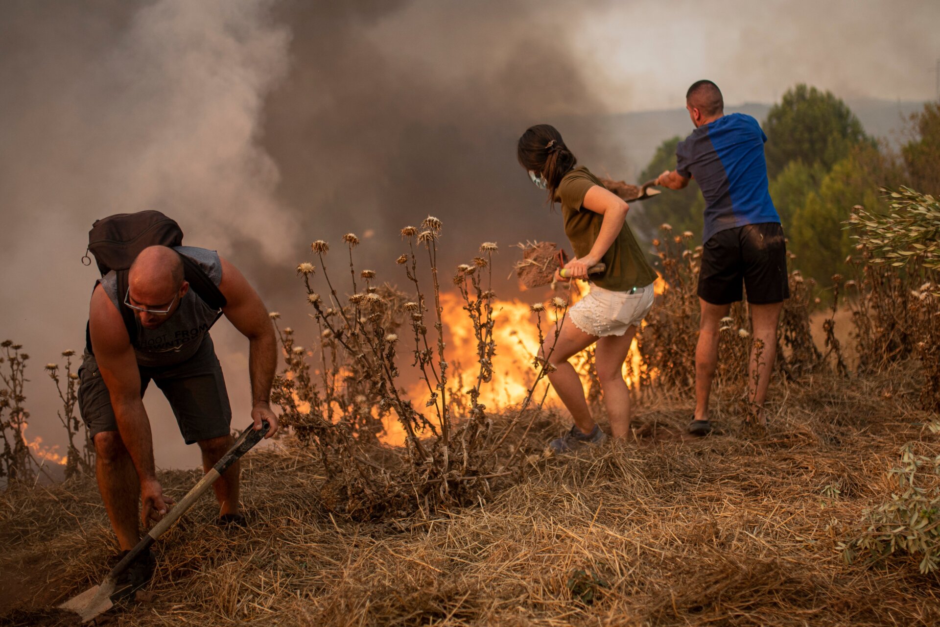 Residents of Sant Fruitós del Bages, Catalonia, Spain work together to extinguish a wildfire on July 17, 2022.
