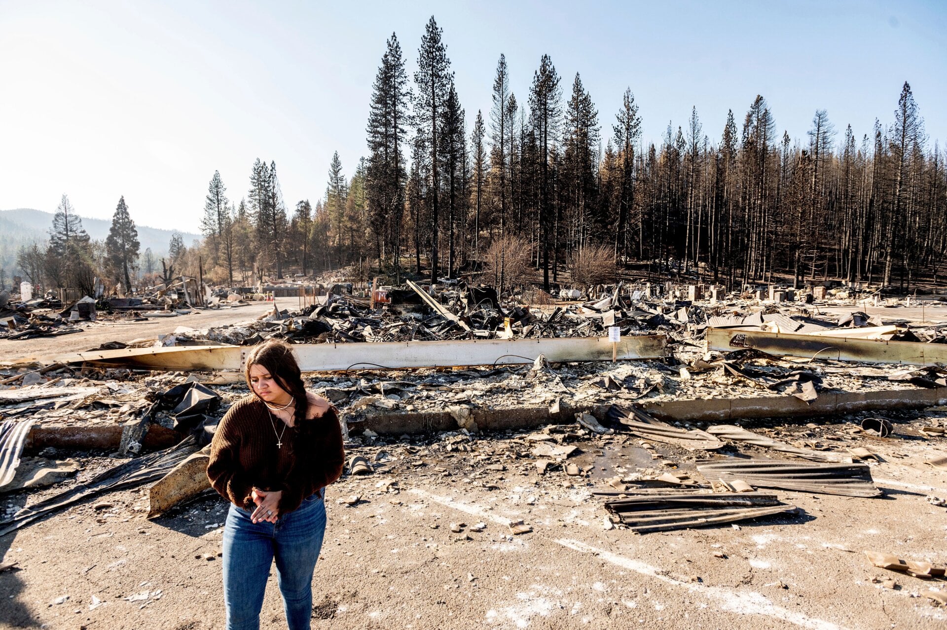 Also following the Dixie Fire: Kyra Cedillos, 14 years old, stands in front of the remains of a hardware store.