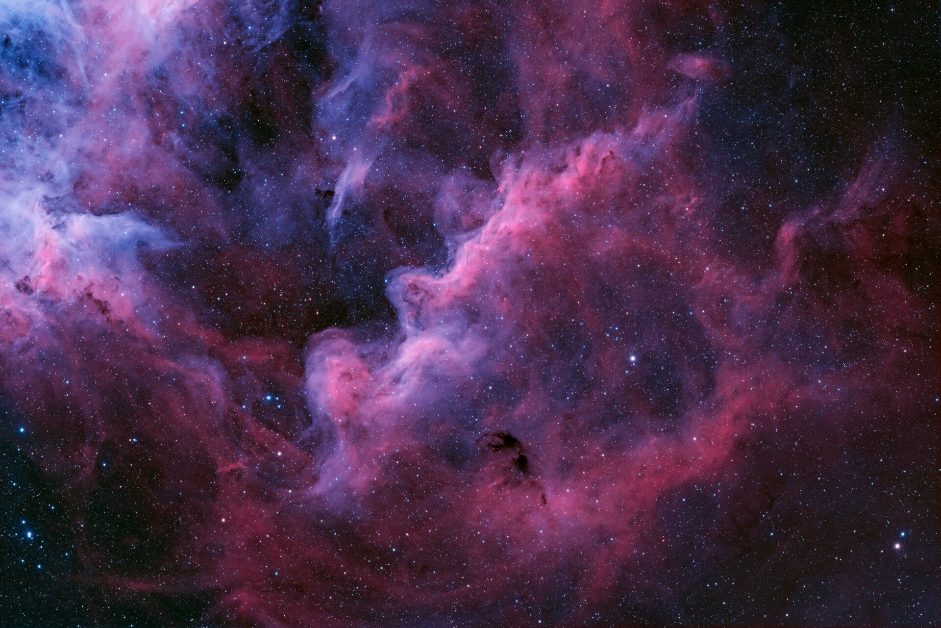 The gassy pinks of a distant nebula.