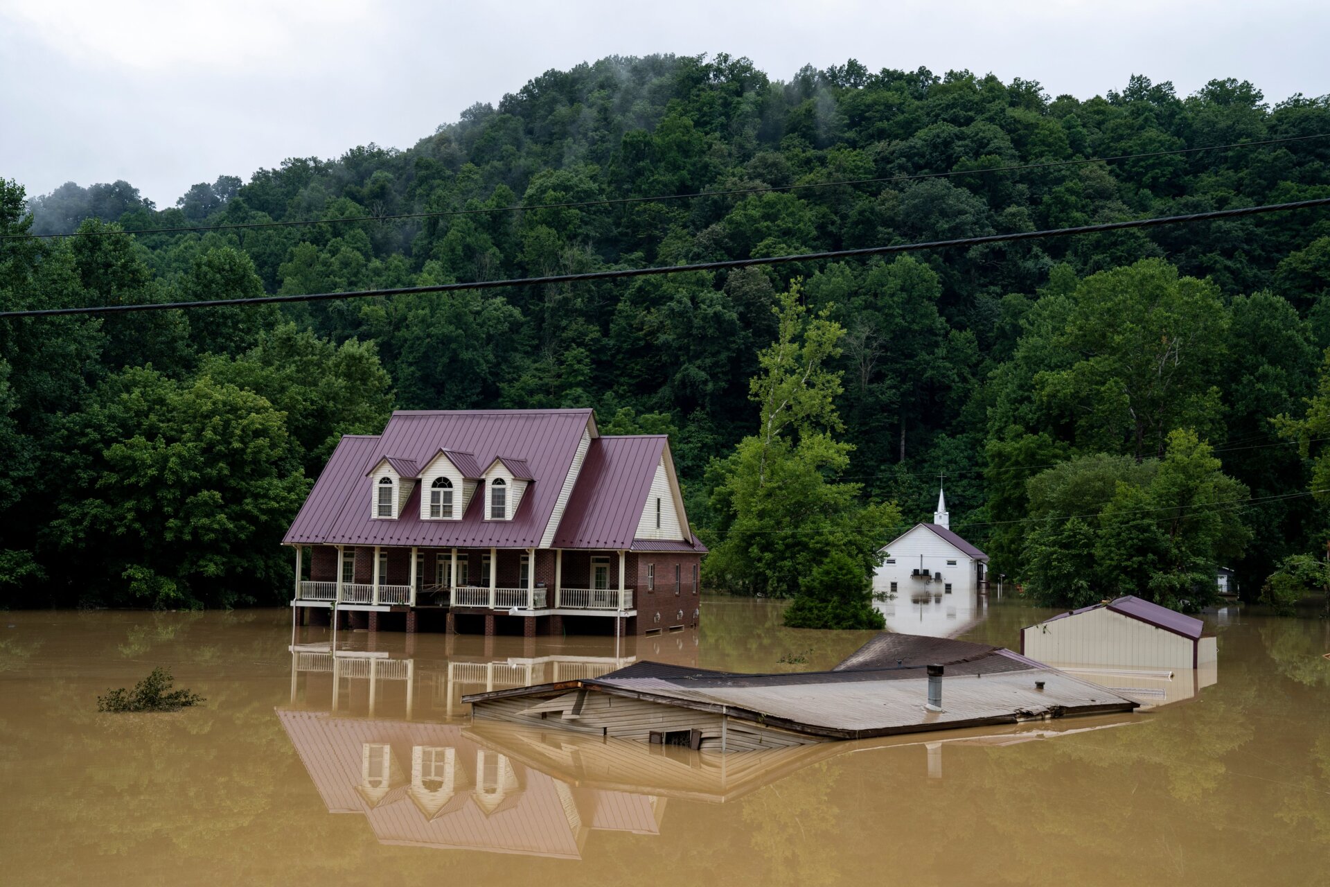 A house is seen almost completely submerged off of the Bert T Combs  Mountain Parkway on July 29, 2022 in Breathitt County, Kentucky. 