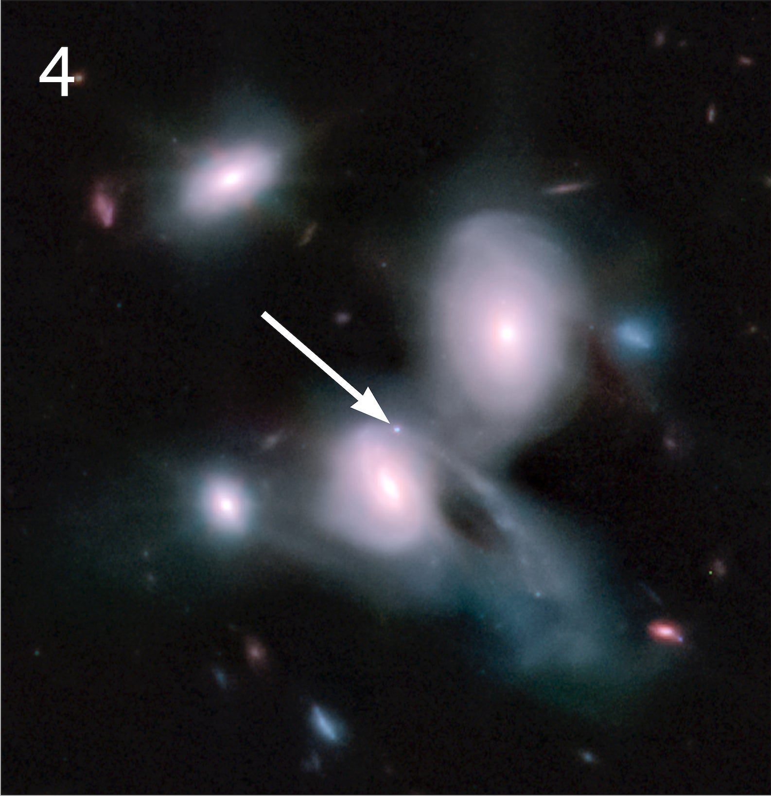 Three pale blue galaxies, two of which are interacting. 