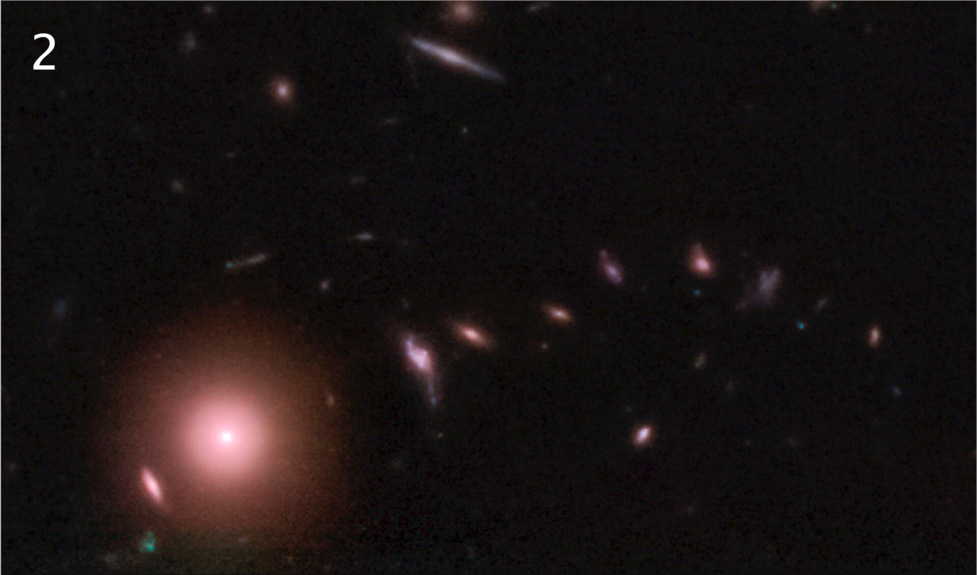 A bright galaxy with a serpentine trail of galaxies to its right.