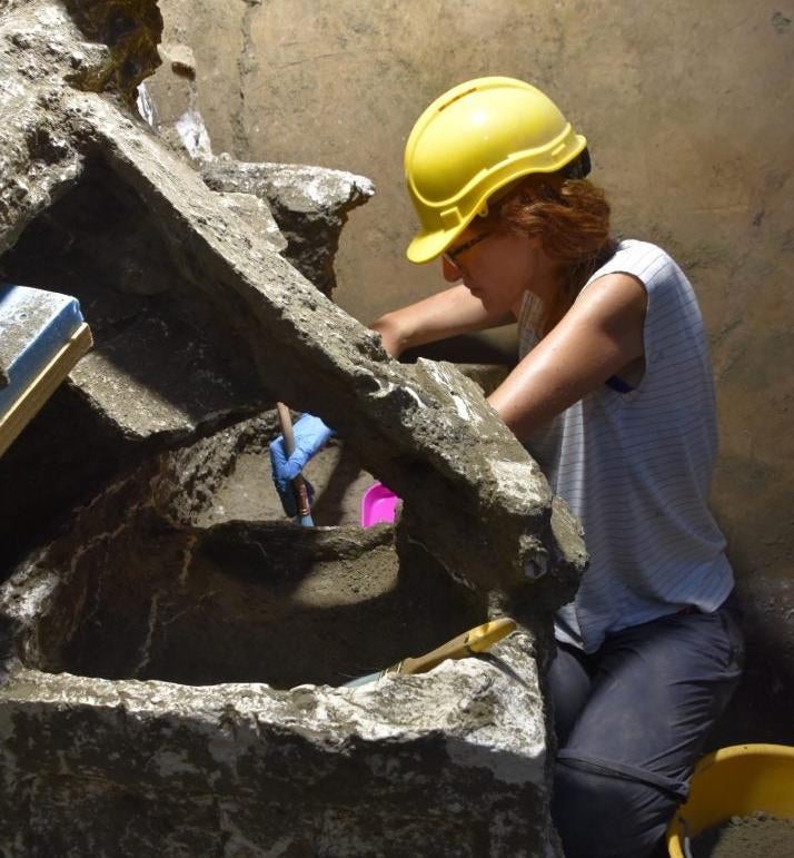 Part of the archaeological team works on the contents of a chest.