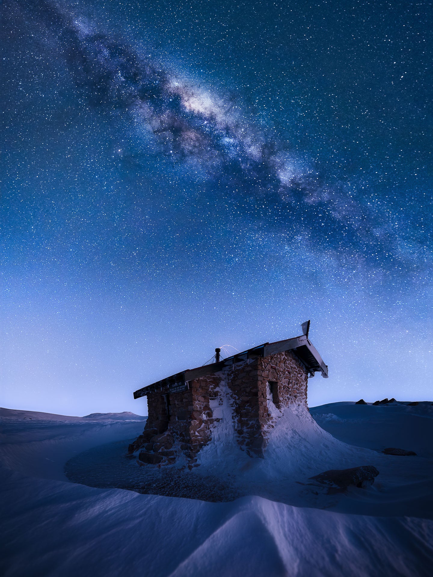 A building in Australia, with the Milky Way looming above.