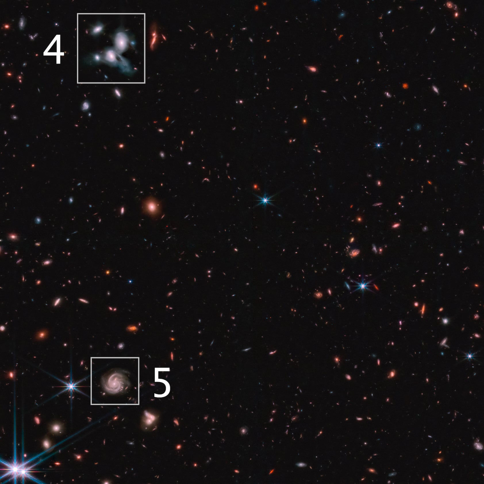 The pale blue galaxies above, and the spiral galaxy below, in one of the NIRCam images.