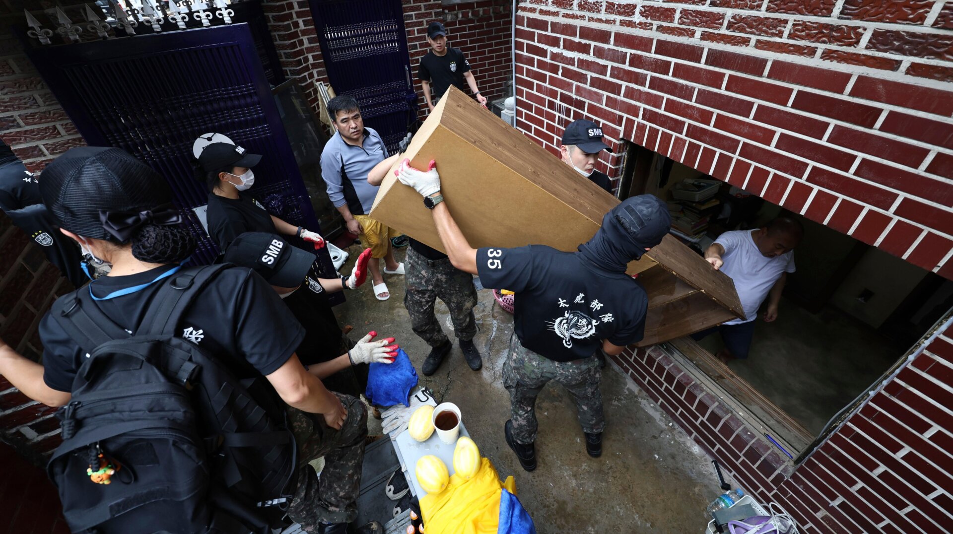 Soldiers clear out debris after waters drained from a banjiha in Seoul, Wednesday, Aug. 10, 2022