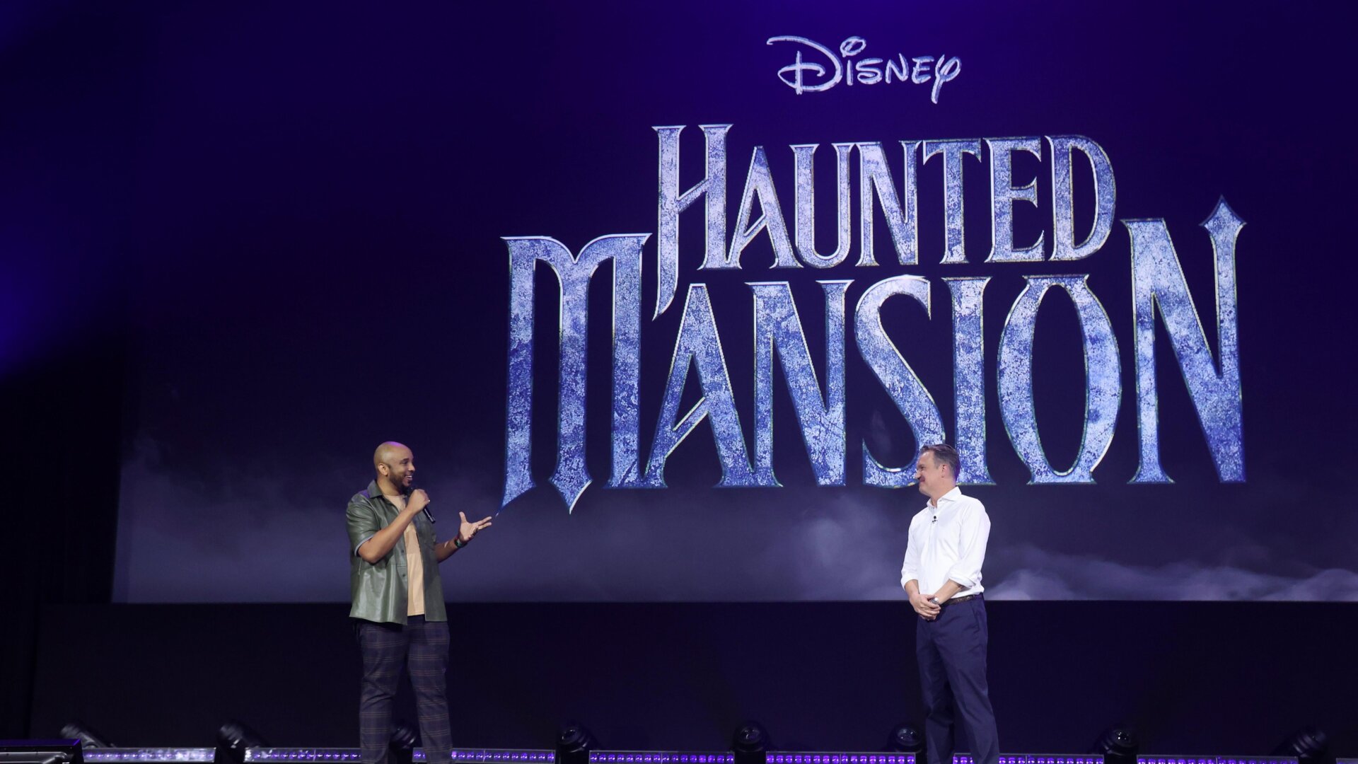 Justin Simien (left) talks haunts galore onstage at D23.