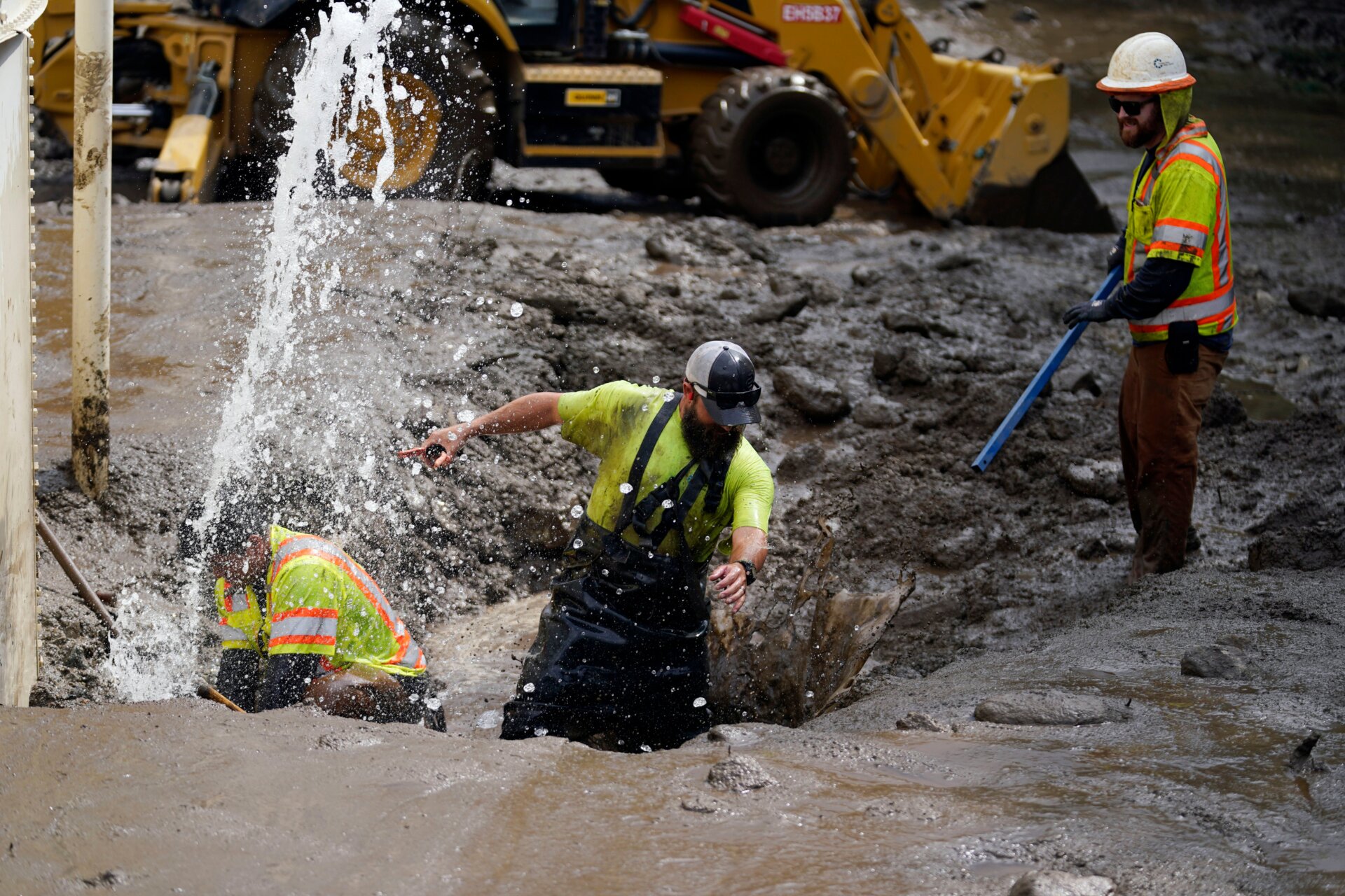 Workers with the Yucaipa Valley Water District work on repairing a reservoir used as a drinking source in the aftermath of a mudslide, on Tuesday, Sept. 13, 2022, in Oak Glen, California. 