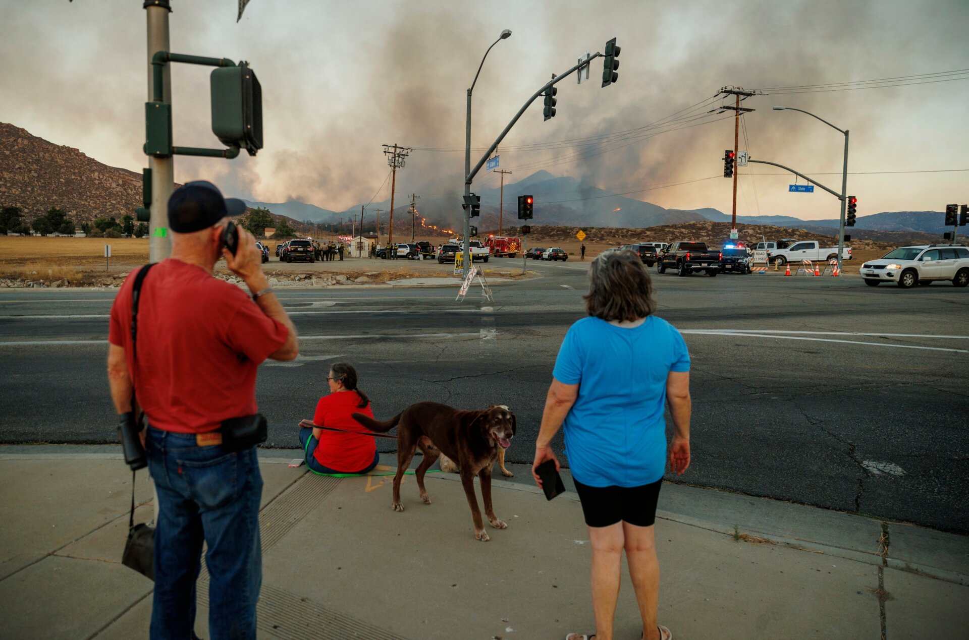 People watch a plume of smoke from the Fairview Fire from a distance on Monday, Sept. 5, 2022, near Hemet, California.