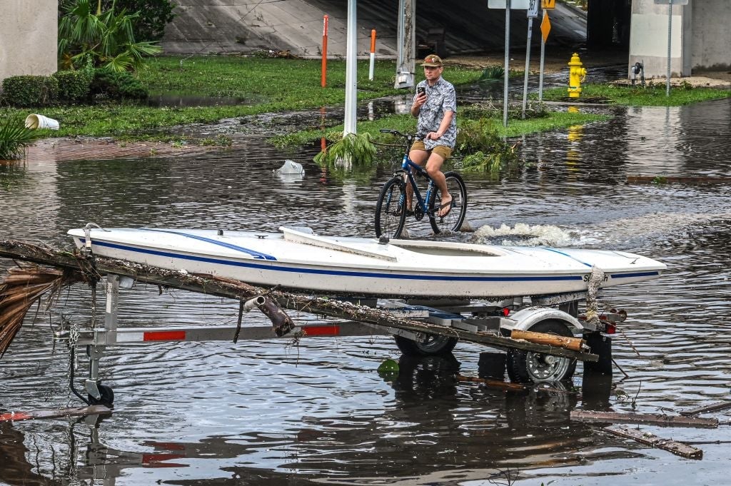 A boat is left stranded on the shore in the aftermath of Hurricane Ian in Fort Myers, Florida, on September 29, 2022.