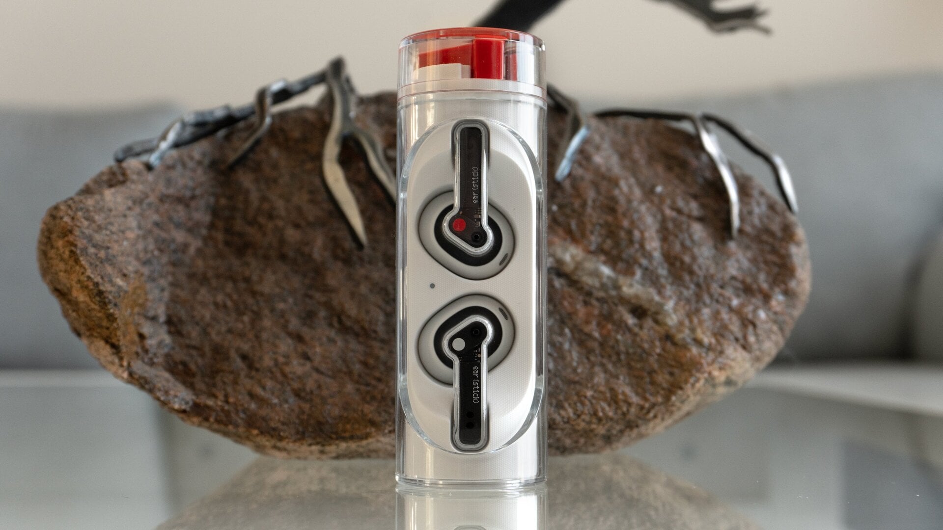 The Nothing Ear (stick)‘s charging case twisted open making the earbuds accessible.