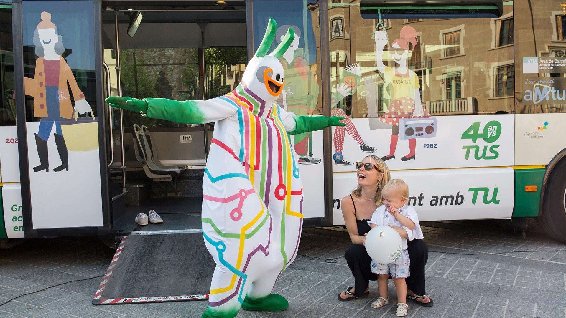 Bussi delights a mother and her child.