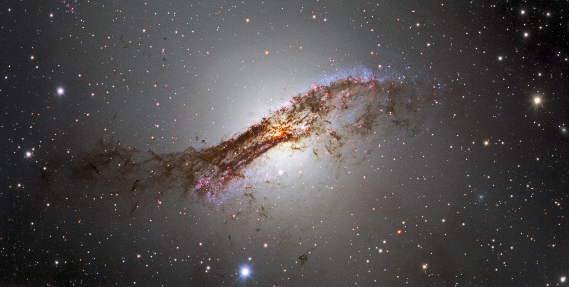 A nifty shot of Centaurus A, seen through a bar of dust.