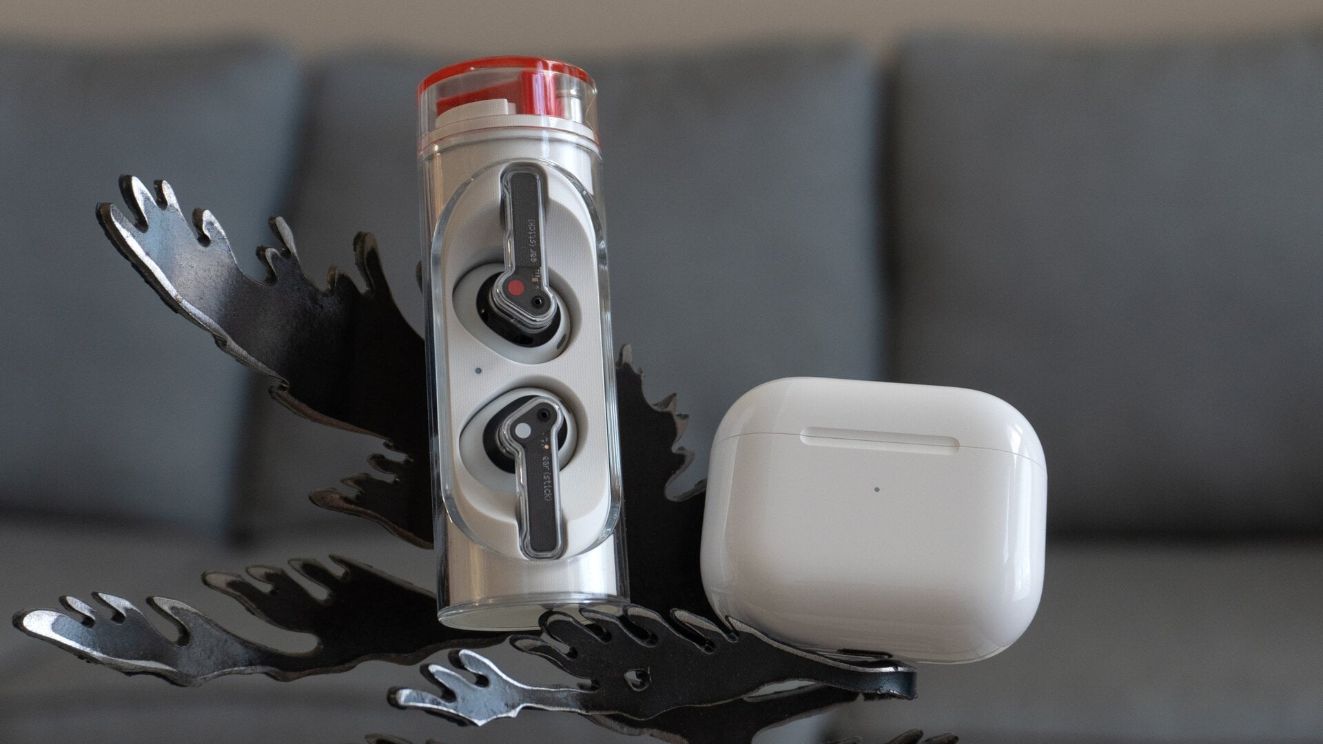 The Nothing Ear (stick)‘s cylindrical charging case compared to the third-gen AirPods very compact charging case (right).