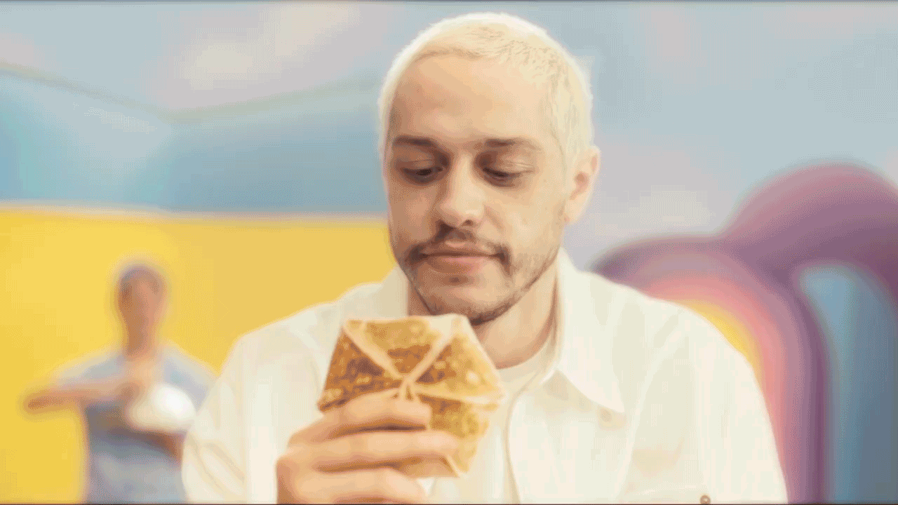 Pete Davidson takes a bite of a Breakfast Crunchwrap in the company’s “The Bell Breakfast” ad.