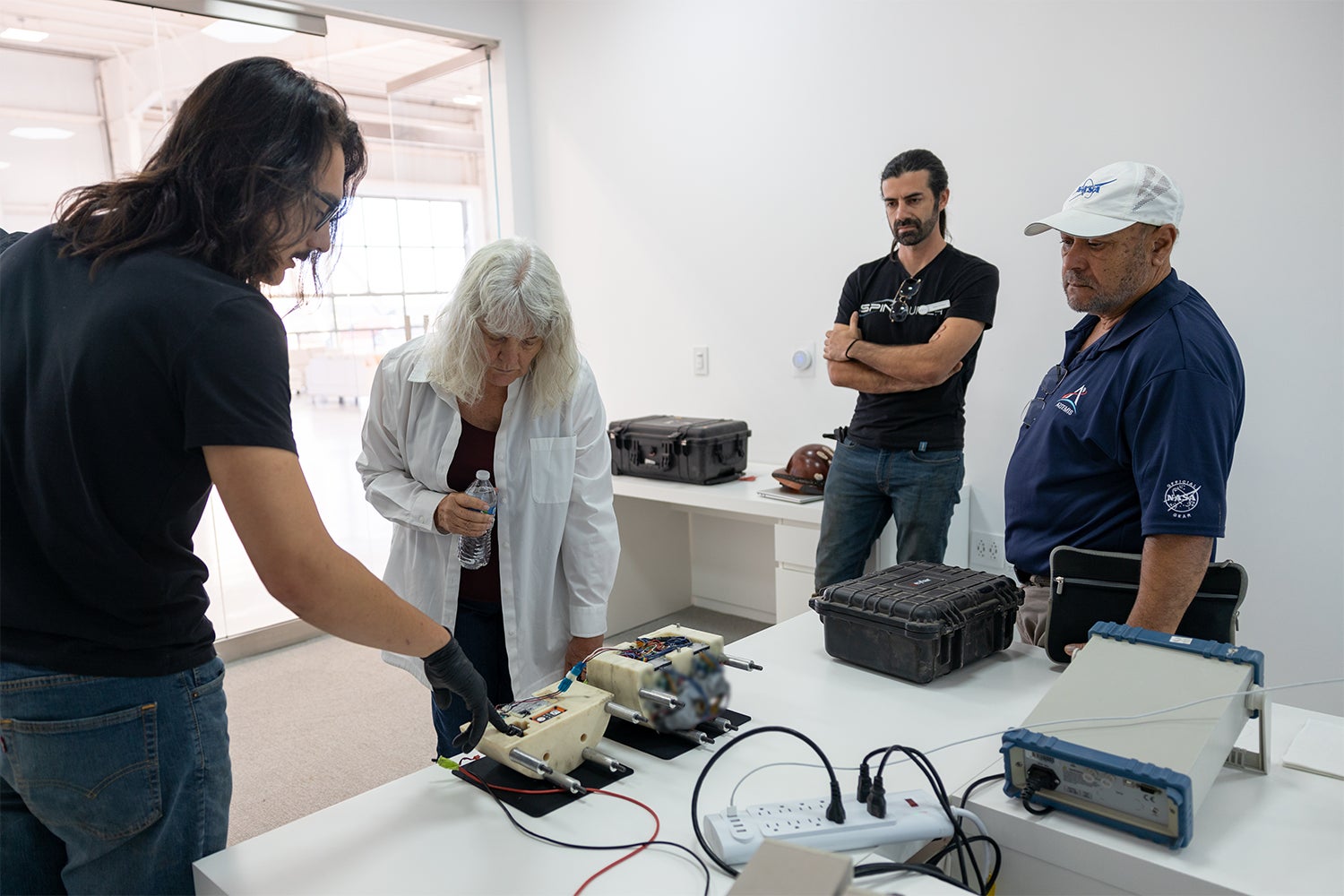 Personnel from NASA’s Flight Opportunities Program viewing the Data Acquisition Unit.