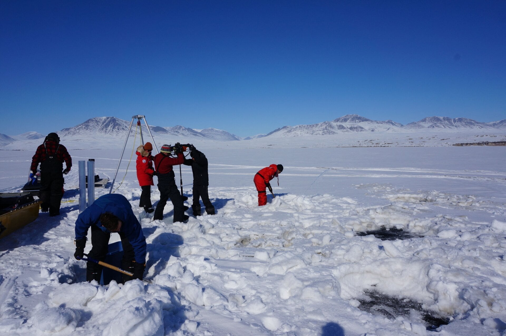 Graham Colby, one of the study scientists, took this photo of researchers drilling into Lake Hazen’s ice to collect sediment samples in 2017.