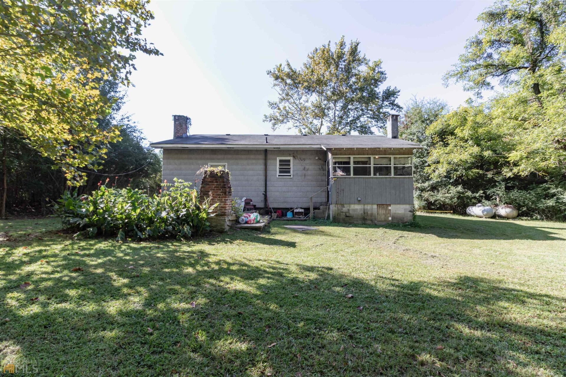 The back of the house looks kind of homey.
